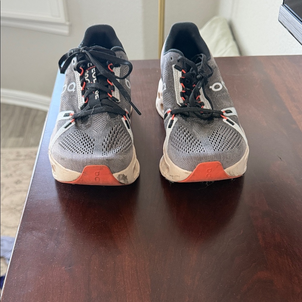 On Running Charcoal and Tangerine Athletic Shoes